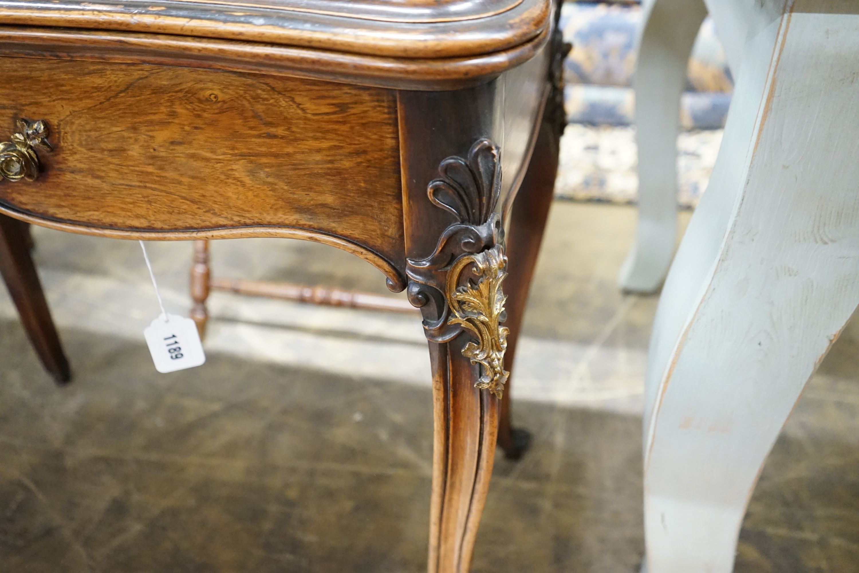 A 19th century French gilt metal mounted rosewood serpentine folding card table, width 82cm, depth 41cm, height 76cm